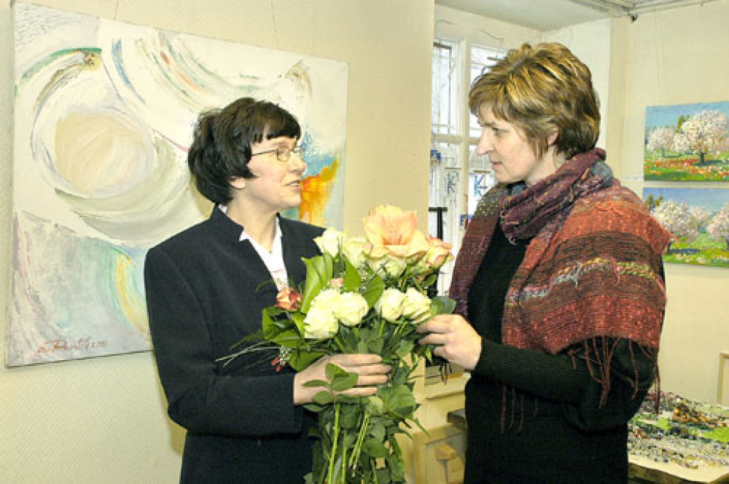 Baltas rozes gleznotājai Īrai Rozentālei (no kreisās) dāvina mākslas salona vadītāja Indra Liepa. 