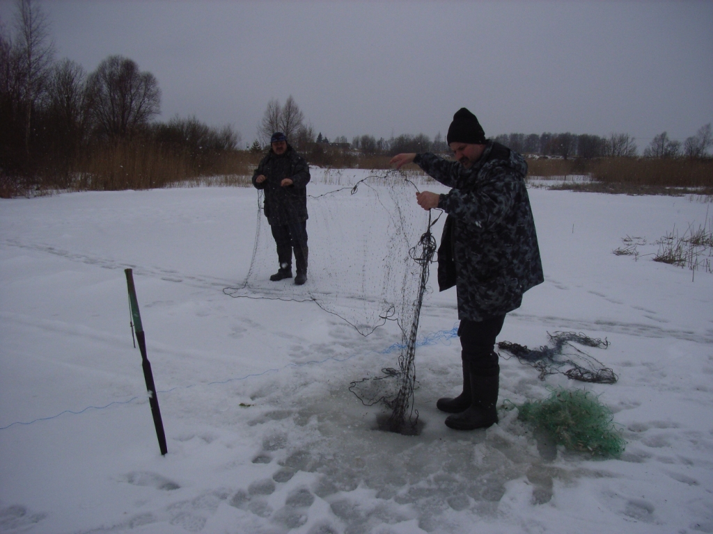 Vides inspektors Ints Roze (no labās) un sabiedriskais palīgs Andis Stīvers no karjeru dīķa Iecavas novadā velk ārā zvejnieku nelikumīgi ievietotos tīklus. 
Autors: No albuma.