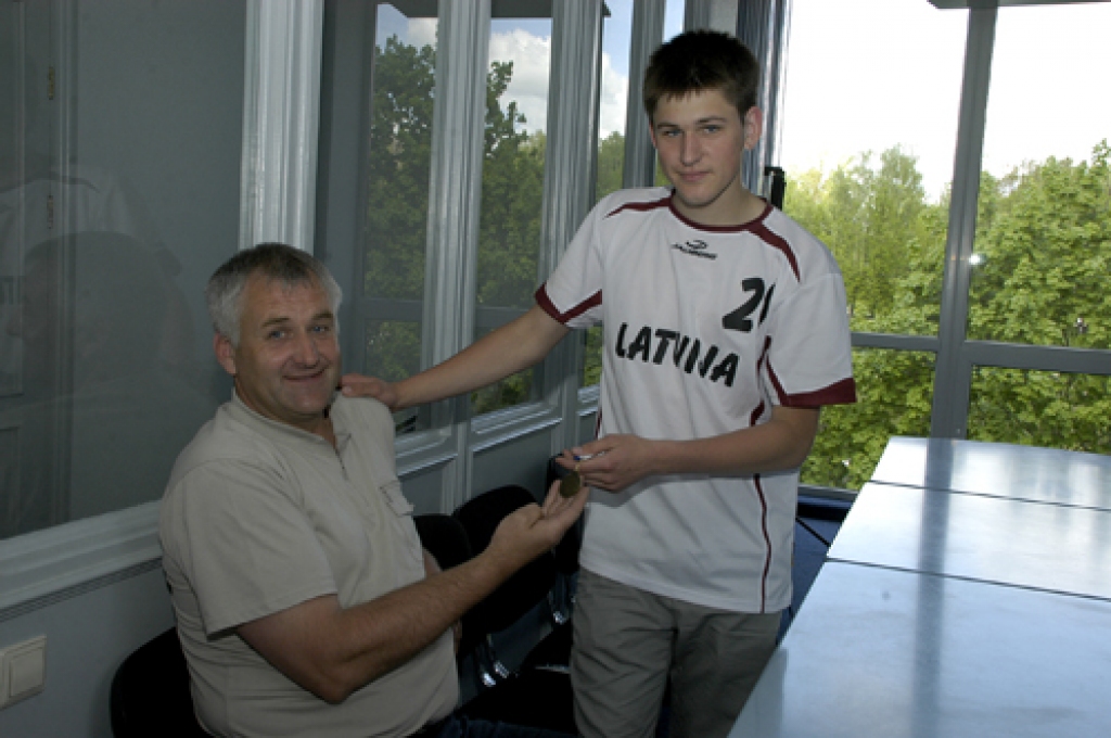 Akmentiņu ģimenē visi trīs dēli nodarbojas ar florbolu. Seniors Jānis, aplūkojot juniora Jāņa (abi attēlā) mājās pārvesto pasaules junioru piektā čempionāta dalībnieku medaļu, sacīja, ka tā ir ceturtā šāda veida relikvija. Trīs piemiņas zīmes no vīriešu pasaules čempionātiem glabā vidējais dēls Māris. 
Autors: Ivars Bogdanovs