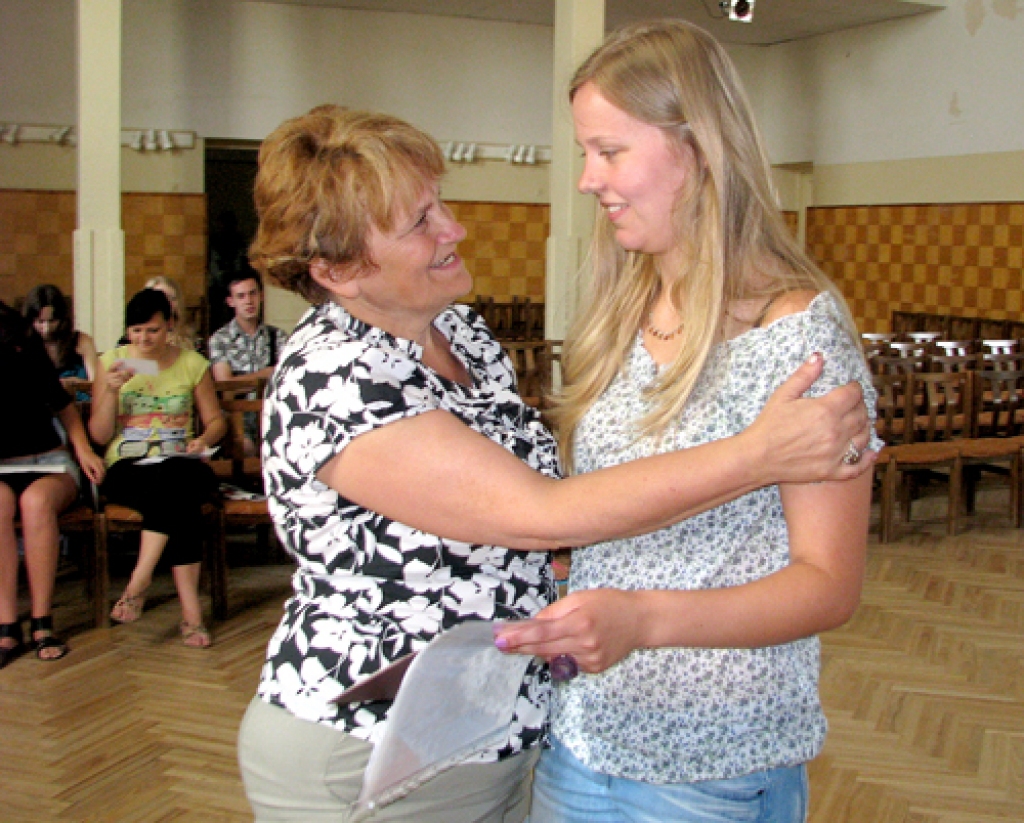 Lāsi Mīlgrāvi (no labās) par viņas lieliskajiem mācību sasniegumiem samīļo nu jau bijusī klases audzinātāja Silvija Dubulte. 
Autors: Vilnis Auzāns