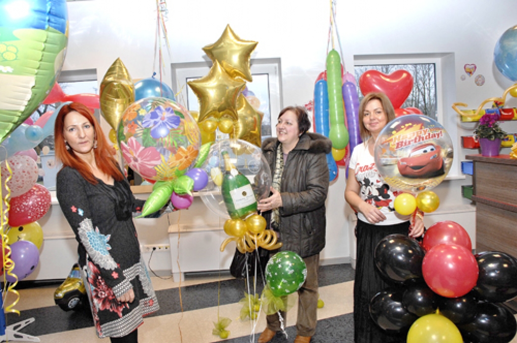 Veikalā «Svētku rēvija» pirmo pircēju, mediķi Mudīti Purviņu (centrā), apkalpo pārdevējas Antra Liepa (no labās) un Gaļina Derunova.  