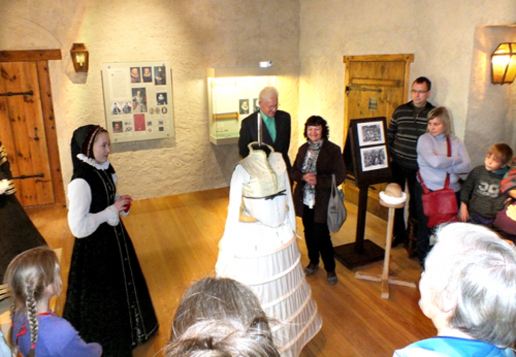 Ilona Taure hofmeistarienes lomā. Apmeklētājiem viņa ierāda, kā jāģērbj pils galma dāma, kuras manekens pašlaik vēl apakšsvārkā.
Autors: Kristaps Ābelnieks