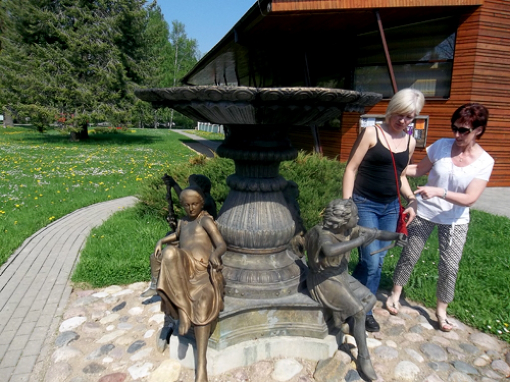 Iecavnieces Baiba Jansone (no kreisās) un Ināra Rikāne Burtnieku novadā pie Gadalaiku vāzes, ko muižkungs savulaik licis izveidot bojāgājušās sievas un meitu piemiņai.