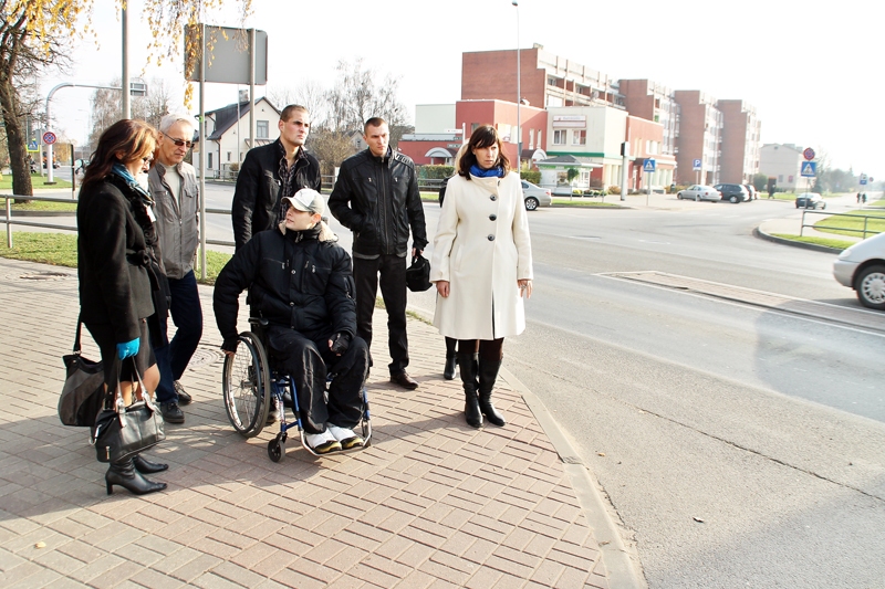 Deniss Juhņevičs (ratiņkrēslā) stāsta par nepatīkami «viltīgo» ietves nobrauktuvi uz Zaļo ielu Bauskā.
Autors: Foto – Uldis Varnevičs