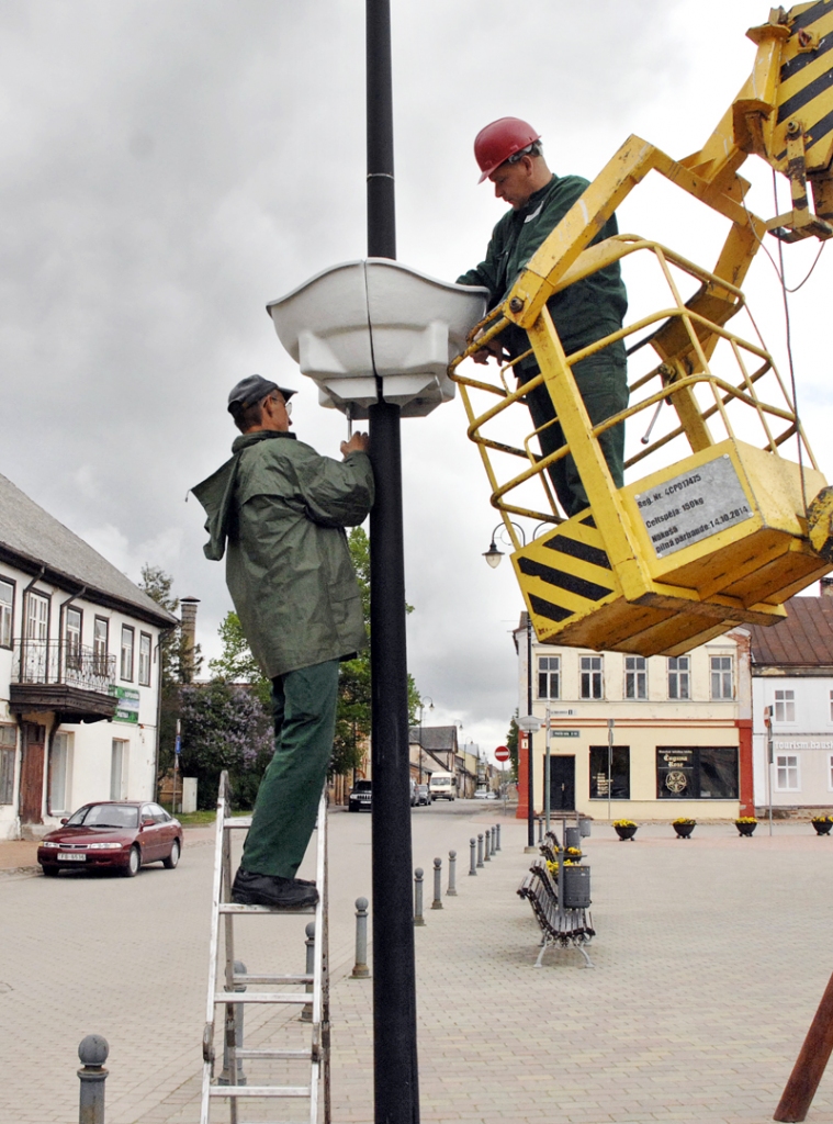 SIA «Vides serviss» strādnieki uzstāda puķu podus pie Rātslaukuma laternām. 
Autors: Foto – Ivars Bogdanovs