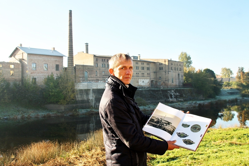 Uldis Veršūns uz Lodinga alus darītavas fona rāda grāmatā «Latvija. Alus darītavas, etiķetes, paliktņi» publicēto Lodinga alus ražotnes fotogrāfiju.
Autors: Uldis Varnevičs