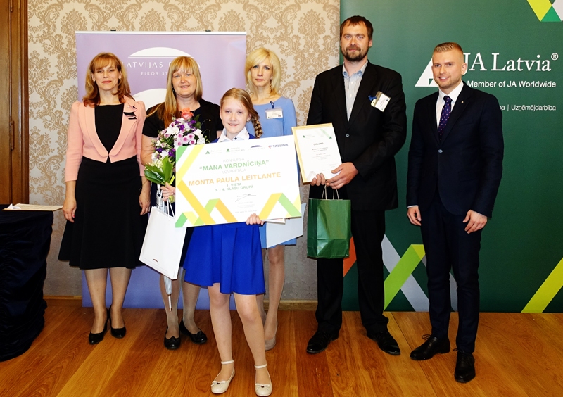 Monta Paula Leitlante ar pedagoģi Solvitu Lauzēju (otrā no labās), vecākiem Ivetu un Māri, konkursa rīkotājiem apbalvošanas ceremonijā.
Autors: no Latvijas Bankas albuma.