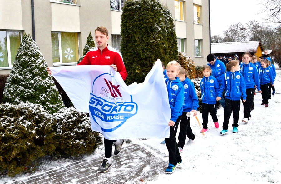 Jānis Baltušs (no kreisās) un Roberts Jakubonis nes projekta «Sporto visa klase» karogu, lai to pie skolas uzvilktu mastā.
Autors: Ivars Bogdanovs