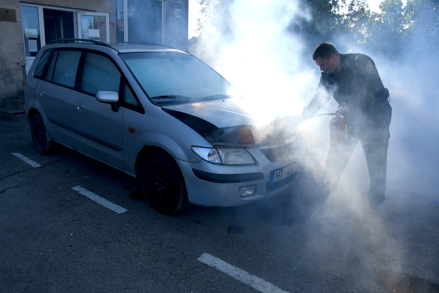 Ugunsdzēsējs-glābējs (autovadītājs) Arnolds Dāboliņš rāda, ka šoferim, atverot automašīnas motora pārsegu, jāraugās, lai ugunij pēc iespējas mazāk piekļūtu skābeklis.
Autors: Ivars Bogdanovs